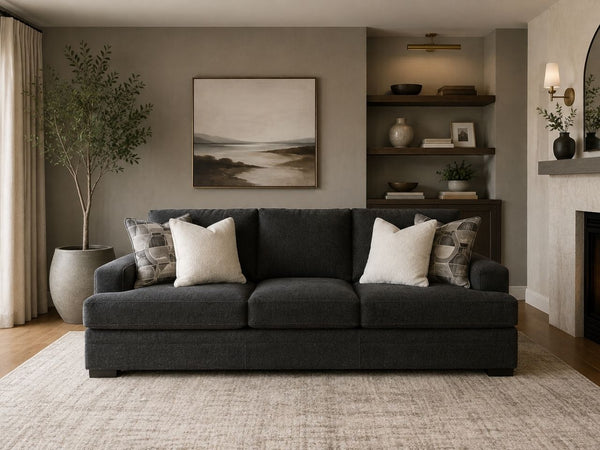 Modern charcoal grey sofa with plush cushions in a Victoria living room