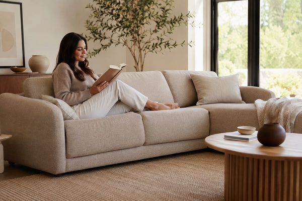 Modern sofa in a warm neutral fabric inside a bright Victoria living room