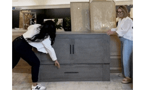 Showhome Furniture staff in Victoria showing how to open and close a bed cabinet